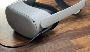 oculus quest with a cable securely plugged in charging the headset to make sure you don't miss out on attending a virtual reality meeting