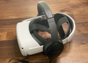 Oculus quest on a wooden desk with Bose over-ear headphones with a wired connection
Helps when attending a larger virtual reality meeting